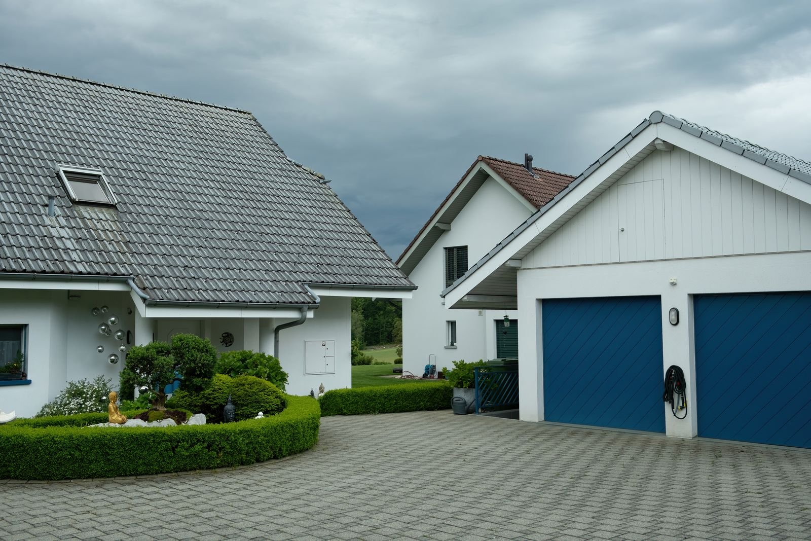 Suburban house with a blue overhead garage door and paved driveway