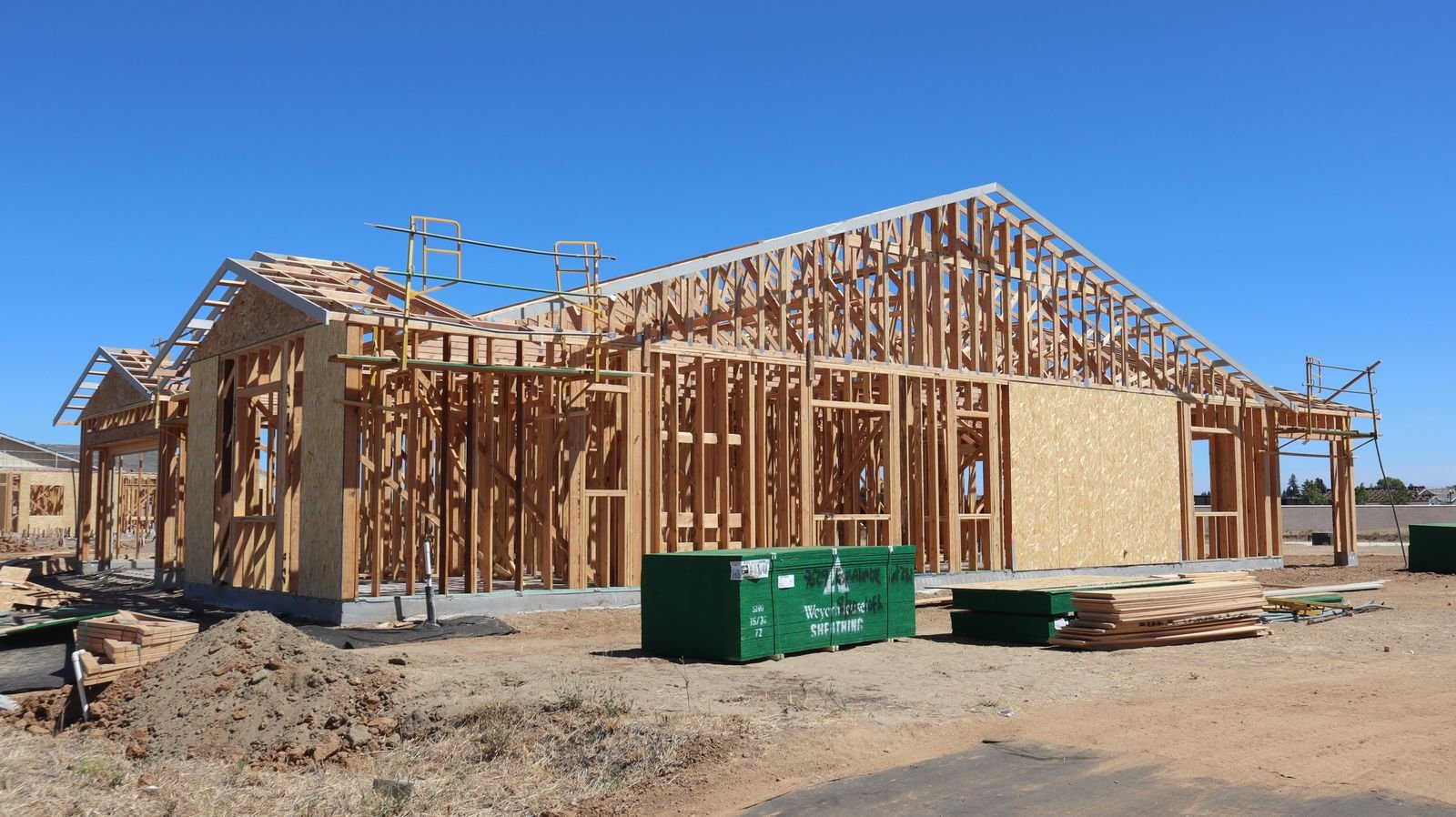 Wood-framed building under construction with roof trusses set